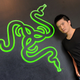 Min-Liang Tan posing in front of the Razer logo in 2011.